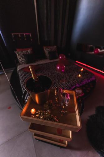 a table with a pot and two glasses on it at Love room - L'escapade du désir in Trouillas