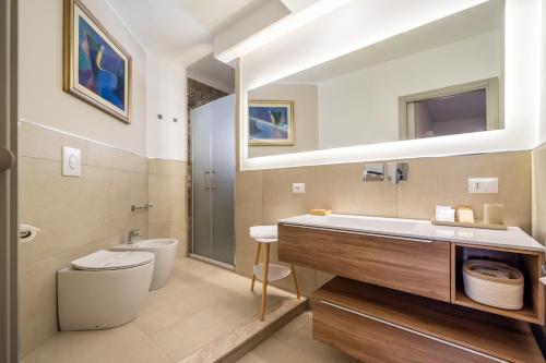 a bathroom with a sink and a toilet at Centoquaranta Apartment in Terrasini