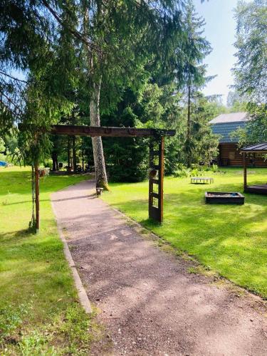 a park with a sign in the grass at Kooli talu puhkemaja in Valingu