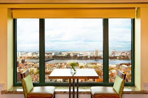 a table and chairs in front of a large window at Sheraton Boston Hotel in Boston