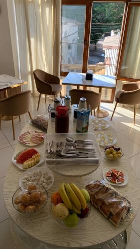 a table with plates of food on top of it at KHAN Hotel in Kokand