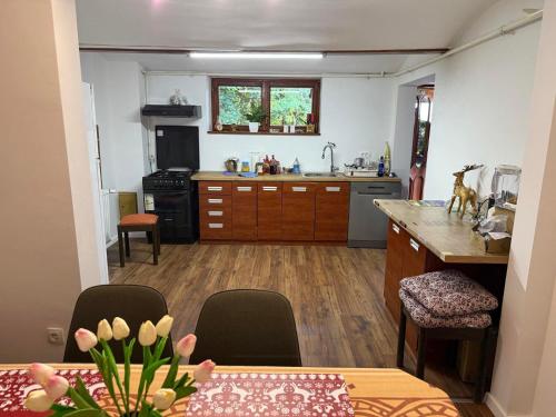 a kitchen with a table and a kitchen with a stove at Vuglovec House in Vuglovec