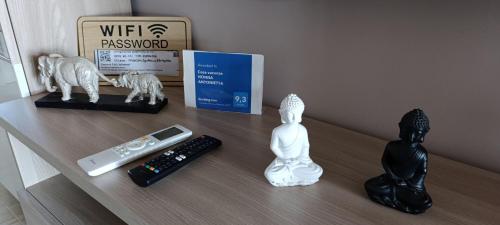 a table with a remote control and statues on it at B&B Nonna Antonietta in Sibari