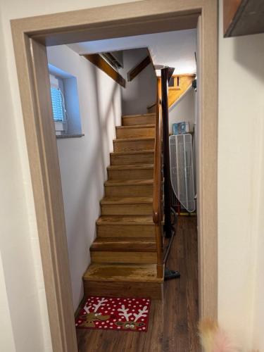 a hallway with a stairway leading up to a room at Vuglovec House in Vuglovec