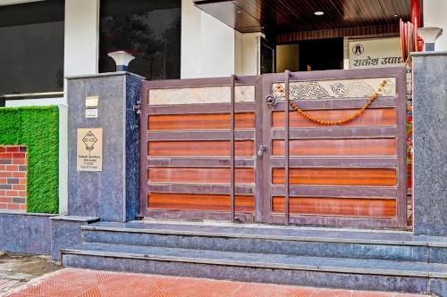 a wooden gate with stairs in front of a building at Hotel O MVD Inn Gomti Nagar in Lucknow