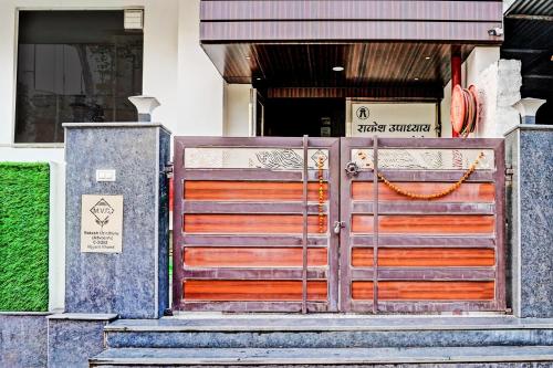 a wooden gate in front of a building at Hotel O MVD Inn Gomti Nagar in Lucknow