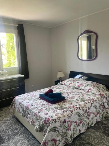 a bedroom with a bed with a floral bedspread at Maison 6 pers. A 5 mn du lac in Montauroux