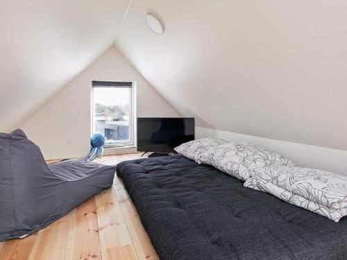 a bedroom with a large bed in a attic at 8 person holiday home in Blåvand in Blåvand