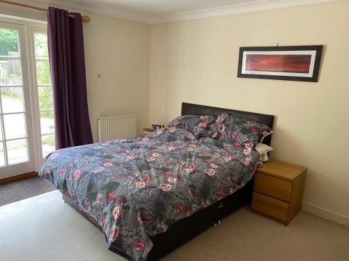 a bedroom with a bed with a colorful comforter at Woodstock in York