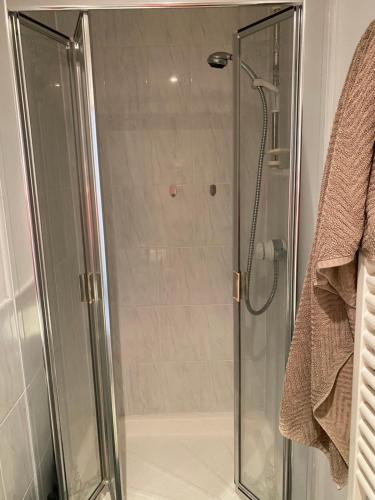 a shower with a glass door in a bathroom at Woodstock in York