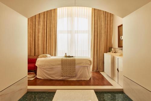 a hotel room with a bed and a window at The Taj Mahal Tower, Mumbai in Mumbai