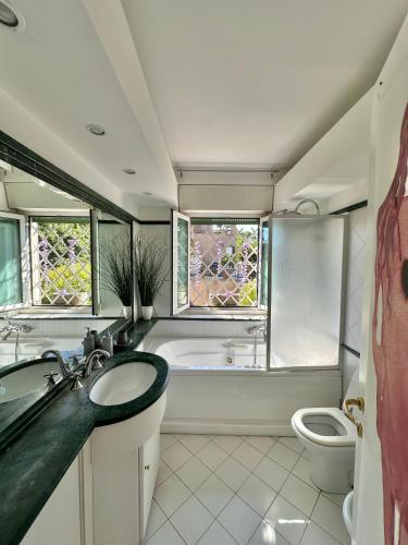 a bathroom with a tub and a sink and a toilet at PENTHOUSE LUXE - Rome in Rome