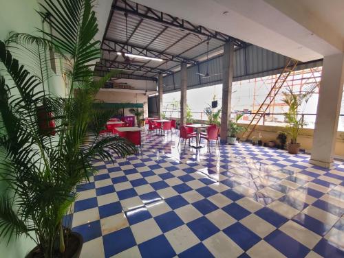 a lobby with a blue and white checkered floor at skyway Rooms pondicherry in Puducherry