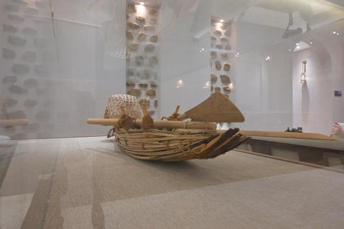 a museum exhibit with a basket on the floor at Nozol Al Rayaheen By Sharjah Collection in Khor Fakkan