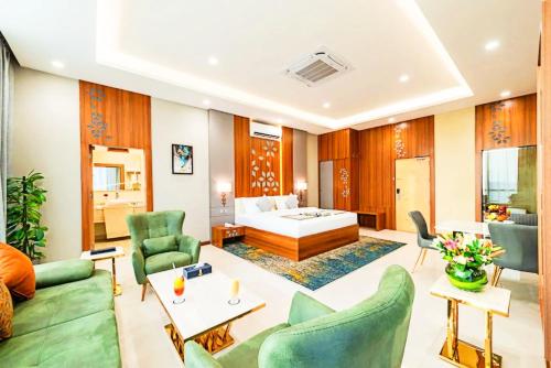 a living room with a bed and a couch and chairs at Sunday Luxury Central formerly Anan hotel in Riyadh
