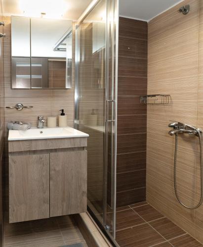 a bathroom with a sink and a shower at Central Thessaloniki Boutique in Thessaloniki
