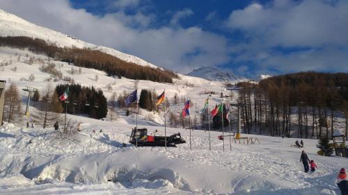 a ski lift on a snow covered slope with flags at VERO RUSTICO ALPiNO in Madesimo