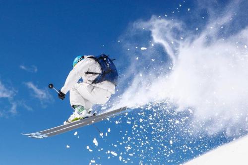 a man flying through the air while riding skis at VERO RUSTICO ALPiNO in Madesimo