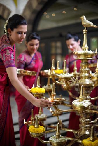 a group of people standing in front of a tray of food at The Taj Mahal Tower, Mumbai in Mumbai
