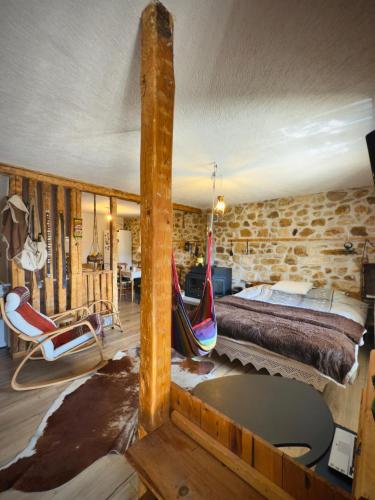 a log cabin bedroom with a bed and hammocks at Books Houses in Beden
