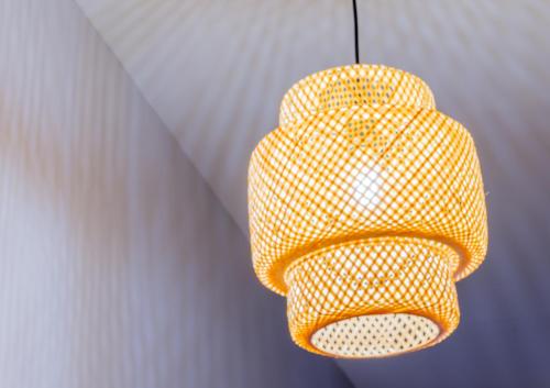 a yellow light fixture hanging from a wall at Sur la route des étoilés - BY PRIMO C0NCIERGERIE in Tournus