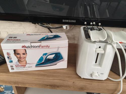 a sewing machine and a box on a table at GuestHouseChampagne in Boscotrecase
