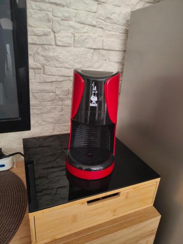a red and black coffee maker in a wooden box at GuestHouseChampagne in Boscotrecase