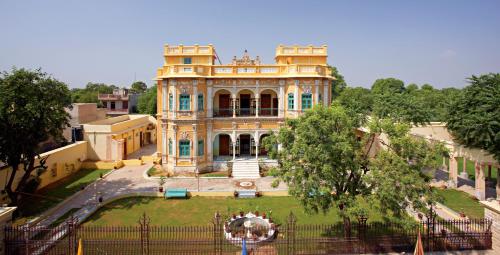 a large building with a garden in front of it at Koolwal Kothi Zinc Journey by The Fern, Nawalgarh, Rajasthan in Nawalgarh