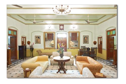 a living room with couches and a table at Koolwal Kothi Zinc Journey by The Fern, Nawalgarh, Rajasthan in Nawalgarh