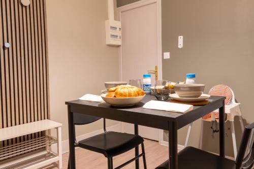 a black table with a bowl of food on it at Sur la route des étoilés - BY PRIMO C0NCIERGERIE in Tournus