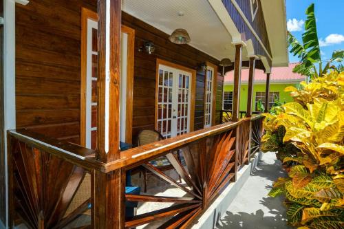 a wooden porch of a house with a wooden fence at River Breeze Villa in Soufrière