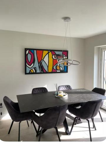 a dining room table with chairs and a painting on the wall at The Sheltuh in Dublin