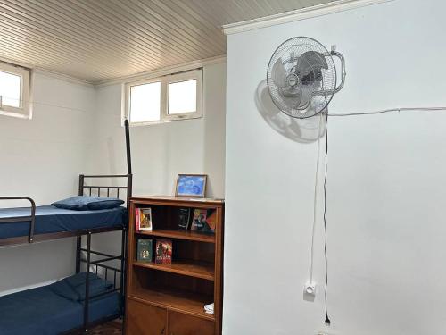 a room with a fan in a room with two bunk beds at Sweet Baku Hostel in Baku