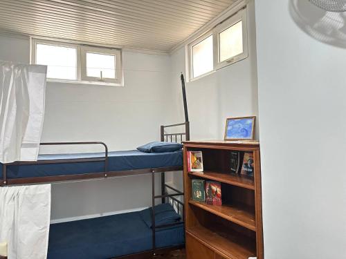 a room with two bunk beds and a book shelf at Sweet Baku Hostel in Baku
