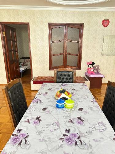 a table with a table cloth with flowers on it at Sweet Baku Hostel in Baku