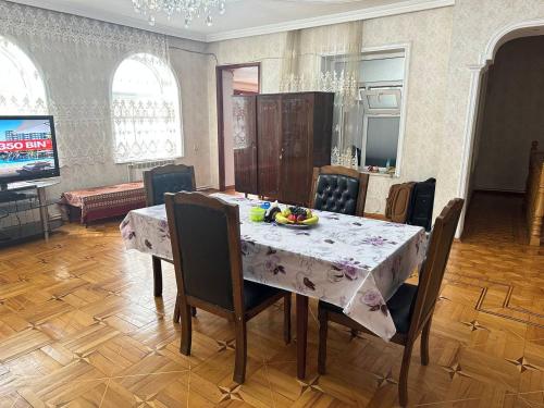 a dining room with a table with chairs and a dining room at Sweet Baku Hostel in Baku