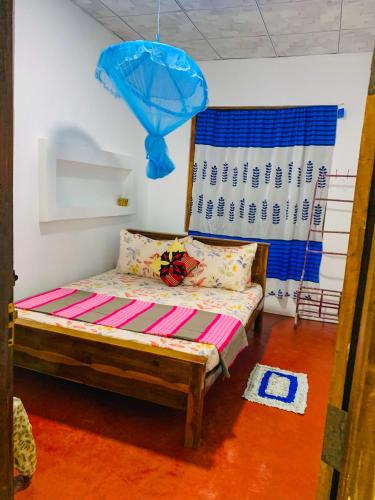 a room with a bed and a blue balloon at Chill Spot Family Room and Hostel in Sigiriya