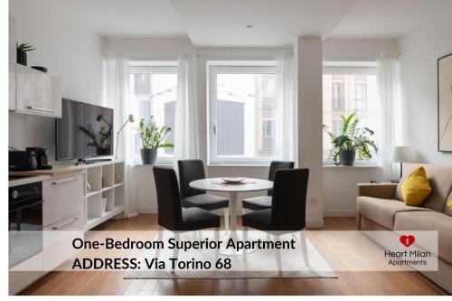 a living room with a table and a couch at Heart Milan Apartments San Sepolcro Duomo in Milan