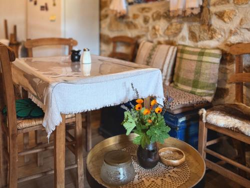 a living room with a table with a vase of flowers at Books Houses in Beden