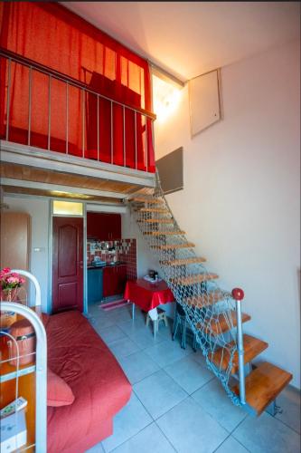 a staircase in a room with a table and a kitchen at Sea Mona in Tivat