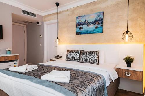 a hotel room with a bed with two towels on it at Galata Door Hotel in Istanbul