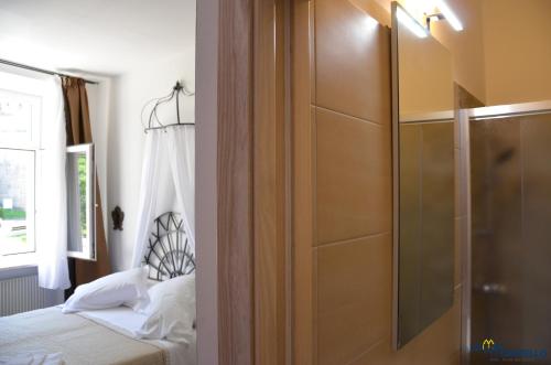 a bedroom with a shower and a bed next to a window at B&B La Loggia Del Castello in Trento