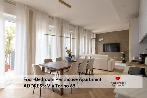 a living room with a dining table and chairs at Heart Milan Apartments San Sepolcro Duomo in Milan