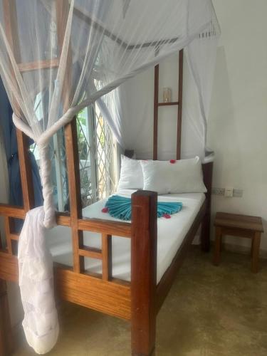 a bedroom with a bed with a canopy at AROYA boutique HOTEL in Zanzibar City