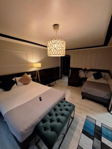 a bedroom with a bed and a couch and a lamp at Hotel Asturias in Viña del Mar
