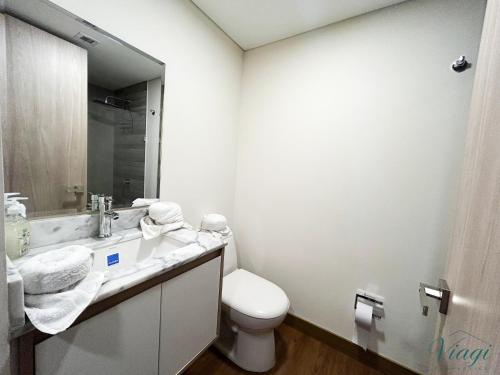 a bathroom with a toilet and a sink and a mirror at Loft estilo Japonés in Bogotá