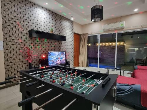 a large black foosball table in a living room at ChinJu PoolVilla in Jomtien Beach