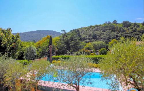 a view of a garden with a swimming pool at 2 Bedroom Amazing Home In Chassiers in Chassiers