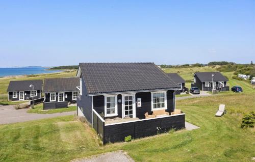an overhead view of a black house on a grass field at Holiday Home Strandgårdsvej Bagenkop Denm in Bagenkop