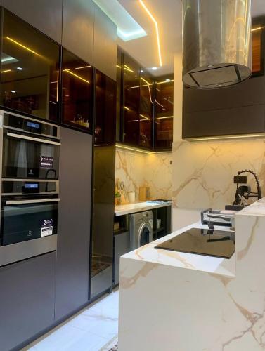 a kitchen with stainless steel appliances and a sink at Second Home in Lekki